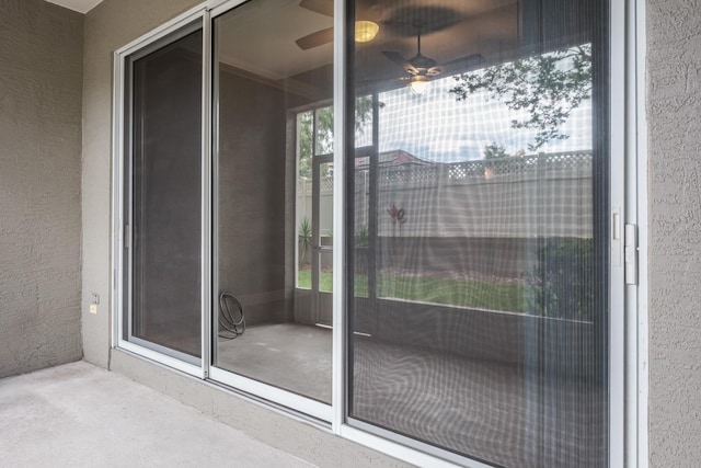 3298 Covered Bridge Dr W, Dunedin, FL 34698 - property entrance with stucco siding, ceiling fan, and a balcony