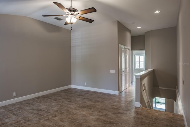 3298 Covered Bridge Dr W, Dunedin, FL 34698 - spare room featuring healthy amount of natural light, a ceiling fan, recessed lighting, wood finished floors, and lofted ceiling