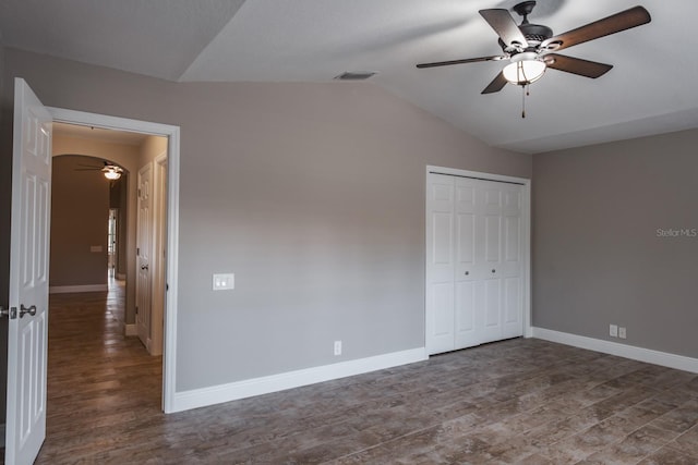 3298 Covered Bridge Dr W, Dunedin, FL 34698 - unfurnished bedroom featuring wood finished floors, lofted ceiling, a closet, and a ceiling fan