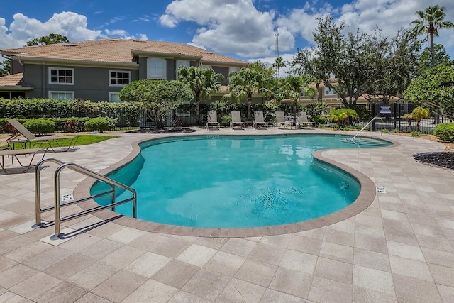 3298 Covered Bridge Dr W, Dunedin, FL 34698 - community pool with a patio