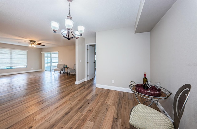 5157 Silent Loop Unit 301, New Port Richey, FL 34652 - unfurnished dining area featuring a chandelier, wood finished floors, and ceiling fan