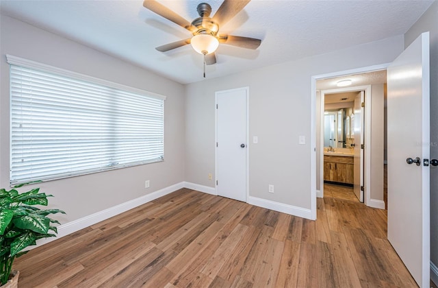 5157 Silent Loop Unit 301, New Port Richey, FL 34652 - unfurnished bedroom featuring wood finished floors and ceiling fan