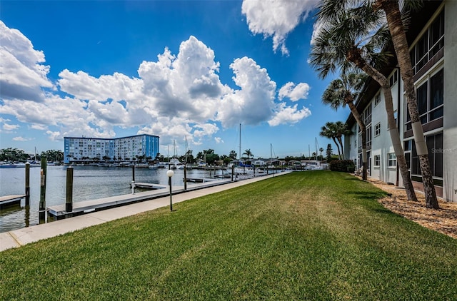 5157 Silent Loop Unit 301, New Port Richey, FL 34652 - view of property's community with a boat dock, a water view, and a lawn