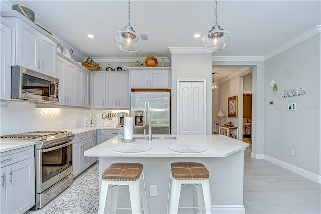 13621 Circa Crossing Dr, Lithia, FL 33547 - kitchen featuring stainless steel appliances, tasteful backsplash, ornamental molding, hanging light fixtures, and a breakfast bar area