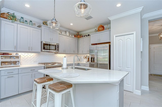 13621 Circa Crossing Dr, Lithia, FL 33547 - kitchen featuring stainless steel appliances, light tile patterned flooring, ornamental molding, tasteful backsplash, and a breakfast bar area