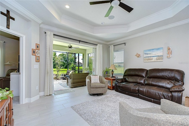 13621 Circa Crossing Dr, Lithia, FL 33547 - living room with a ceiling fan, a tray ceiling, crown molding, and light tile patterned floors