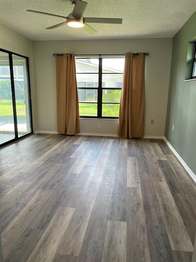 3610 54th St W Unit B8, Bradenton, FL 34209 - empty room with wood finished floors, a textured ceiling, plenty of natural light, and a ceiling fan