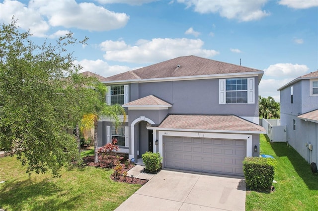 1811 Palm Warbler Ln, Ruskin, FL 33570 - view of front facade with stucco siding, driveway, a garage, and a shingled roof