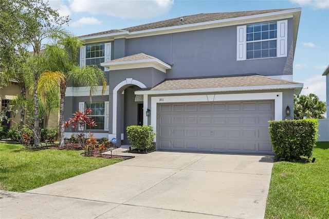 1811 Palm Warbler Ln, Ruskin, FL 33570 - traditional-style house featuring concrete driveway, stucco siding, a front yard, and a shingled roof