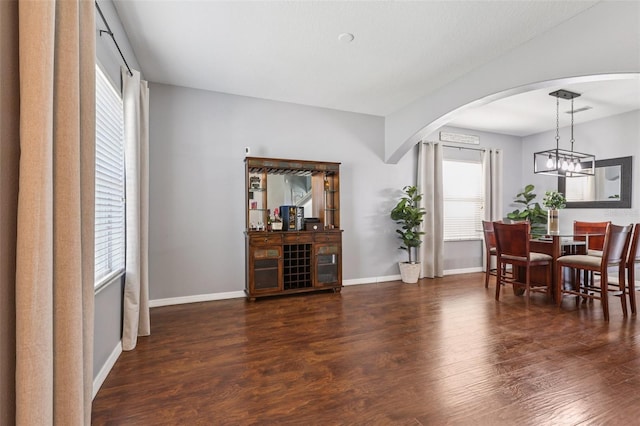 1811 Palm Warbler Ln, Ruskin, FL 33570 - dining space featuring arched walkways, wood finished floors, healthy amount of natural light, and a chandelier