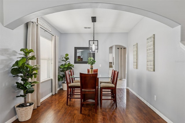 1811 Palm Warbler Ln, Ruskin, FL 33570 - dining area featuring arched walkways and dark wood finished floors