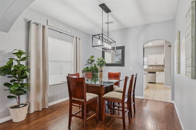 1811 Palm Warbler Ln, Ruskin, FL 33570 - dining room with hardwood / wood-style floors and arched walkways