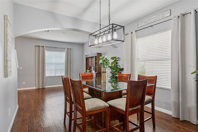 1811 Palm Warbler Ln, Ruskin, FL 33570 - dining area with arched walkways and dark wood-type flooring