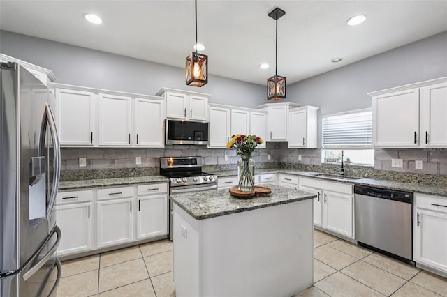 1811 Palm Warbler Ln, Ruskin, FL 33570 - kitchen with stainless steel appliances, backsplash, white cabinets, light tile patterned floors, and recessed lighting