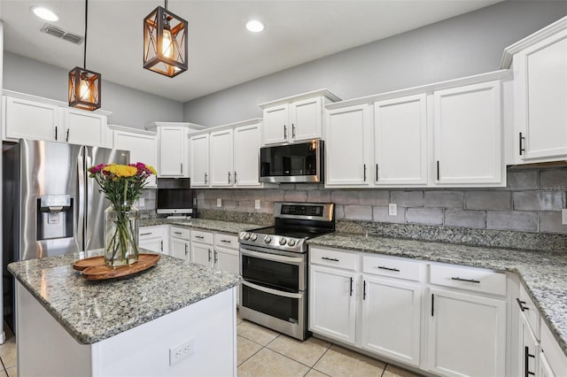 1811 Palm Warbler Ln, Ruskin, FL 33570 - kitchen with appliances with stainless steel finishes, light tile patterned floors, white cabinetry, tasteful backsplash, and recessed lighting