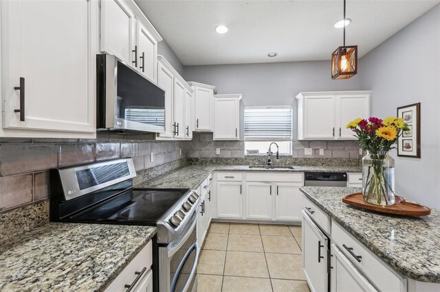 1811 Palm Warbler Ln, Ruskin, FL 33570 - kitchen featuring stainless steel appliances, backsplash, white cabinets, decorative light fixtures, and light stone counters