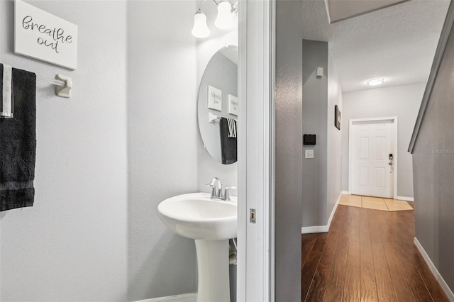 1811 Palm Warbler Ln, Ruskin, FL 33570 - bathroom with hardwood / wood-style flooring and baseboards
