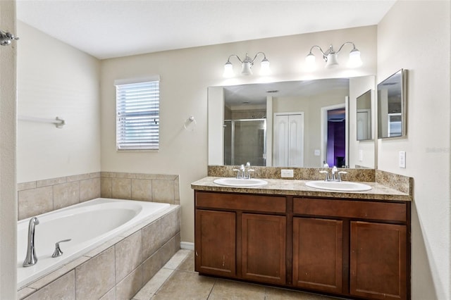1811 Palm Warbler Ln, Ruskin, FL 33570 - bathroom featuring a shower stall, double vanity, a bath, and tile patterned floors
