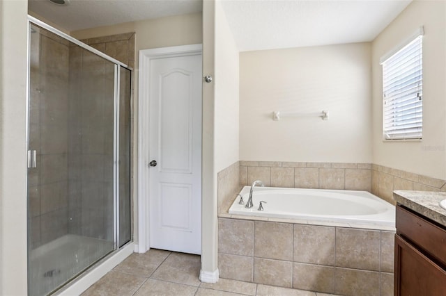 1811 Palm Warbler Ln, Ruskin, FL 33570 - full bath featuring vanity, a bath, a stall shower, and tile patterned flooring