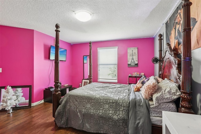 1811 Palm Warbler Ln, Ruskin, FL 33570 - bedroom with wood finished floors and a textured ceiling
