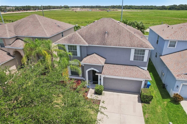1811 Palm Warbler Ln, Ruskin, FL 33570 - view of front of home with stucco siding, an attached garage, driveway, and a front lawn