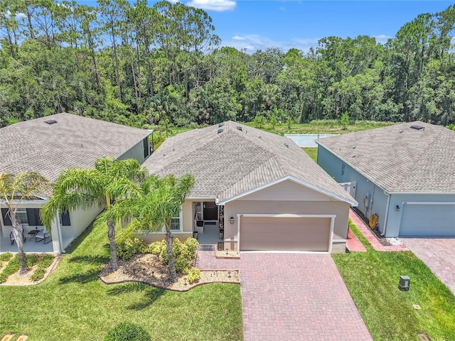 289 Siesta Vista Ct, Davenport, FL 33896 - single story home featuring stucco siding, a garage, decorative driveway, and a front yard