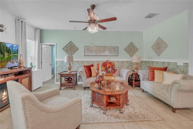 289 Siesta Vista Ct, Davenport, FL 33896 - living area featuring ceiling fan, tile patterned flooring, and a wainscoted wall