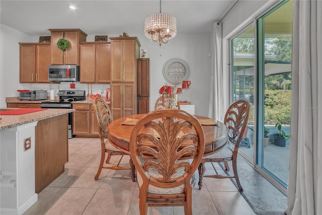 289 Siesta Vista Ct, Davenport, FL 33896 - dining area with a chandelier and light tile patterned flooring