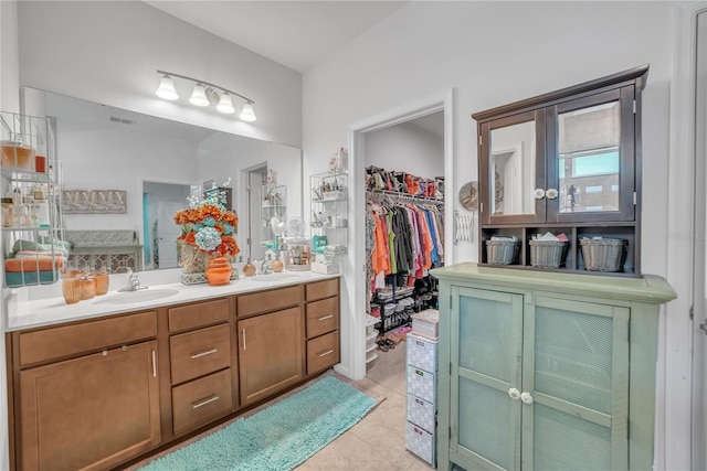 289 Siesta Vista Ct, Davenport, FL 33896 - bathroom with double vanity, a spacious closet, and tile patterned floors