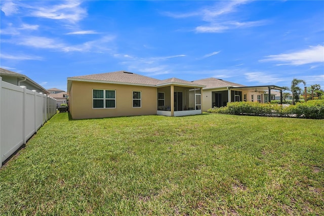 289 Siesta Vista Ct, Davenport, FL 33896 - rear view of property featuring a sunroom, stucco siding, and a shingled roof