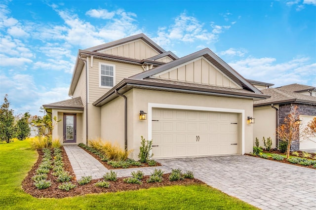 7728 Somersworth Dr, Kissimmee, FL 34747 - craftsman-style house featuring board and batten siding, decorative driveway, a garage, roof with shingles, and stucco siding