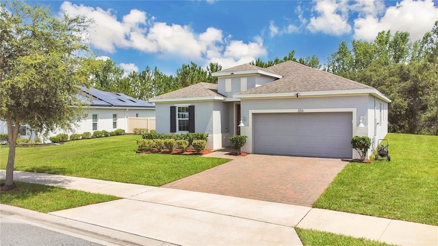 356 Irving Bend Dr, Groveland, FL 34736 - view of front of home with stucco siding, decorative driveway, roof with shingles, and a front lawn