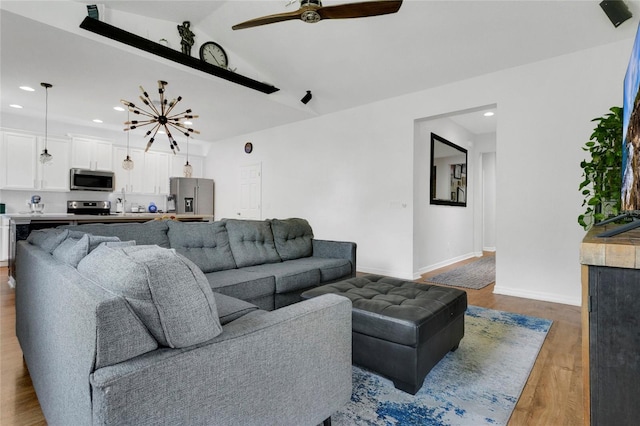 356 Irving Bend Dr, Groveland, FL 34736 - living area with wood finished floors, ceiling fan, vaulted ceiling, and recessed lighting