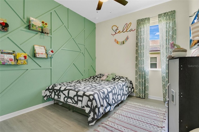 356 Irving Bend Dr, Groveland, FL 34736 - bedroom with wood finished floors and ceiling fan