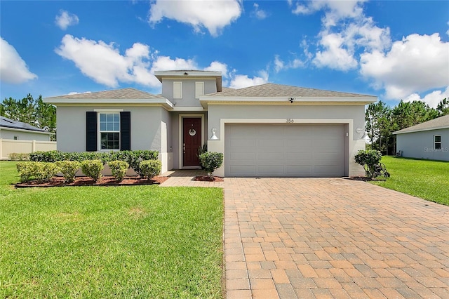 356 Irving Bend Dr, Groveland, FL 34736 - view of front of home featuring decorative driveway, stucco siding, and an attached garage