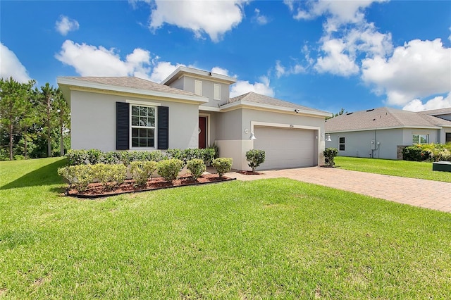 356 Irving Bend Dr, Groveland, FL 34736 - view of front of home with stucco siding, driveway, an attached garage, and a front lawn
