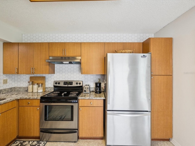 4220 Revere Cir, New Port Richey, FL 34653 - kitchen featuring stainless steel appliances, under cabinet range hood, a textured ceiling, decorative backsplash, and light stone counters
