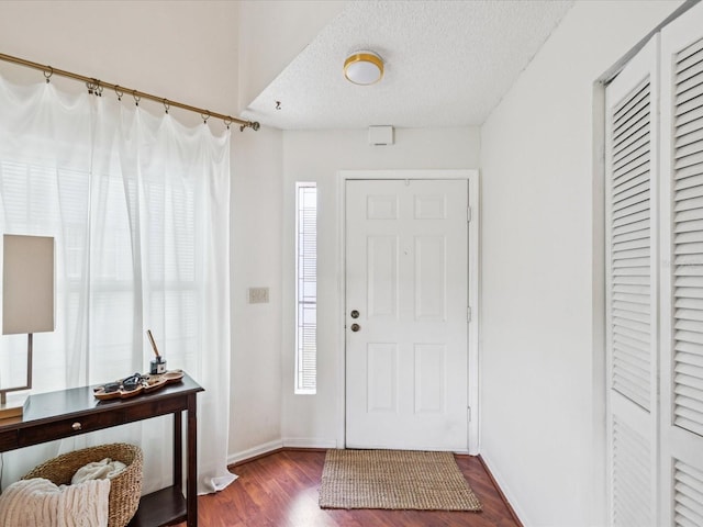 4220 Revere Cir, New Port Richey, FL 34653 - foyer entrance with dark wood-type flooring and a textured ceiling