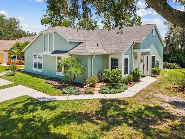 4220 Revere Cir, New Port Richey, FL 34653 - ranch-style house featuring stucco siding, a front lawn, and a shingled roof