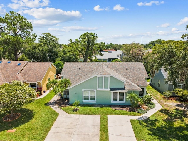 4220 Revere Cir, New Port Richey, FL 34653 - rear view of house featuring a yard and stucco siding