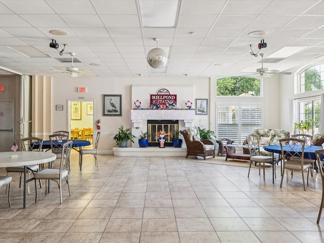 4220 Revere Cir, New Port Richey, FL 34653 - living area featuring ceiling fan, light tile patterned floors, a fireplace, and a drop ceiling