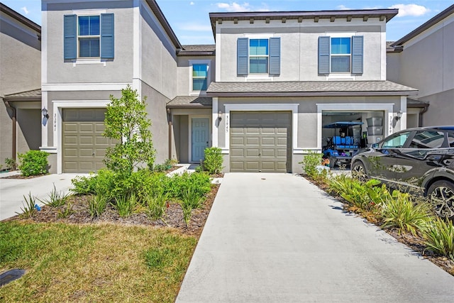 31945 Blue Passing Loop, Wesley Chapel, FL 33545 - multi unit property featuring an attached garage, driveway, and stucco siding