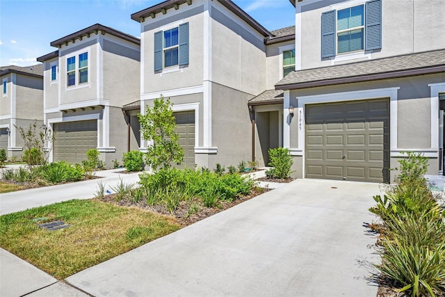 31945 Blue Passing Loop, Wesley Chapel, FL 33545 - view of front facade with an attached garage, stucco siding, and concrete driveway