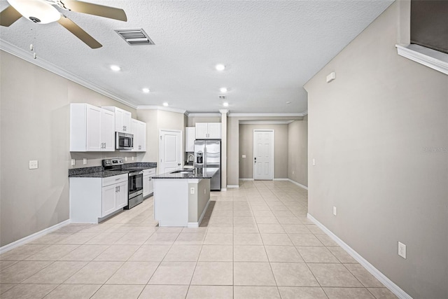 31945 Blue Passing Loop, Wesley Chapel, FL 33545 - kitchen with appliances with stainless steel finishes, crown molding, a ceiling fan, white cabinets, and a center island with sink