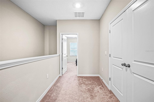31945 Blue Passing Loop, Wesley Chapel, FL 33545 - hallway featuring carpet floors and a textured ceiling