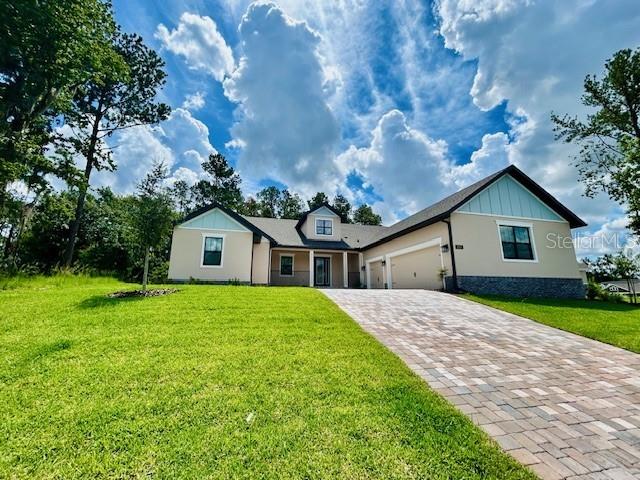 4800 Hickory Oak Dr, Brooksville, FL 34601 - single story home featuring decorative driveway, a garage, and a front yard