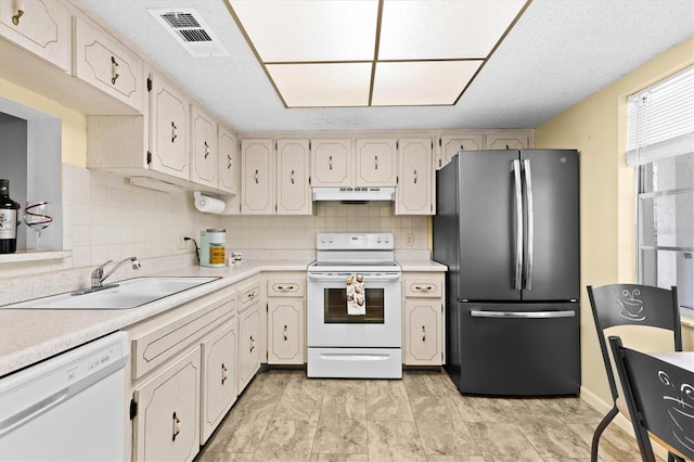 840 Virginia St Unit 301, Dunedin, FL 34698 - kitchen with white appliances, under cabinet range hood, light countertops, and tasteful backsplash