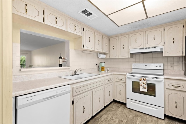 840 Virginia St Unit 301, Dunedin, FL 34698 - kitchen with white appliances, under cabinet range hood, tasteful backsplash, and light countertops