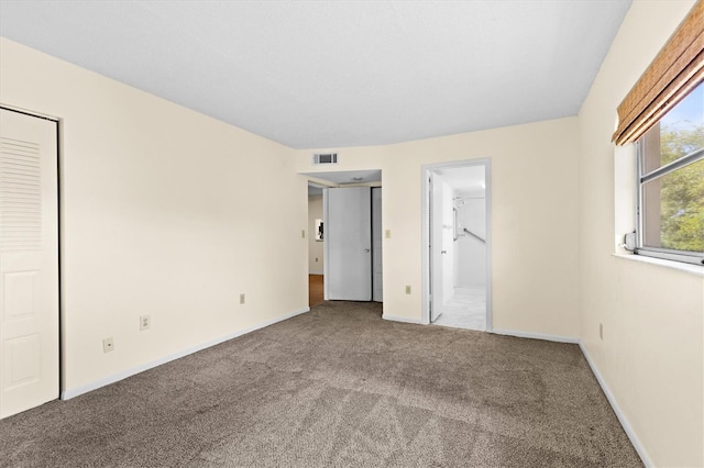 840 Virginia St Unit 301, Dunedin, FL 34698 - unfurnished bedroom with carpet and ensuite bathroom