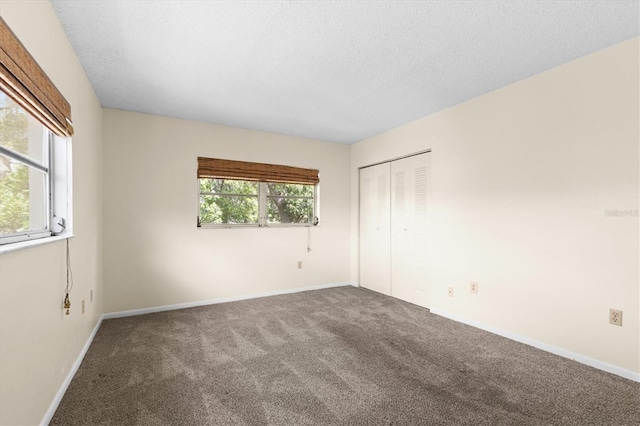 840 Virginia St Unit 301, Dunedin, FL 34698 - unfurnished bedroom with carpet, a closet, and a textured ceiling